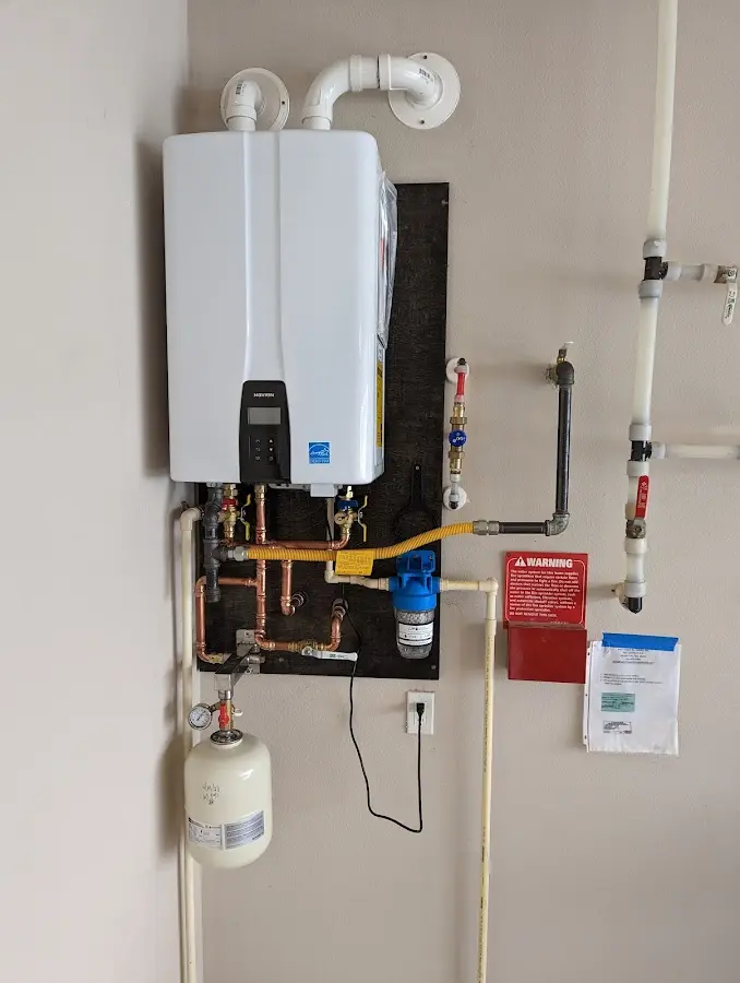 Professional plumber installing copper piping in a Buhl home